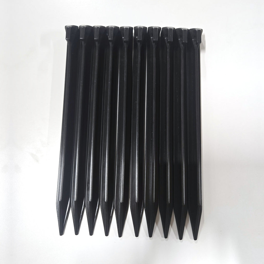 Pack of ten black BruteLine ground pegs side by side
