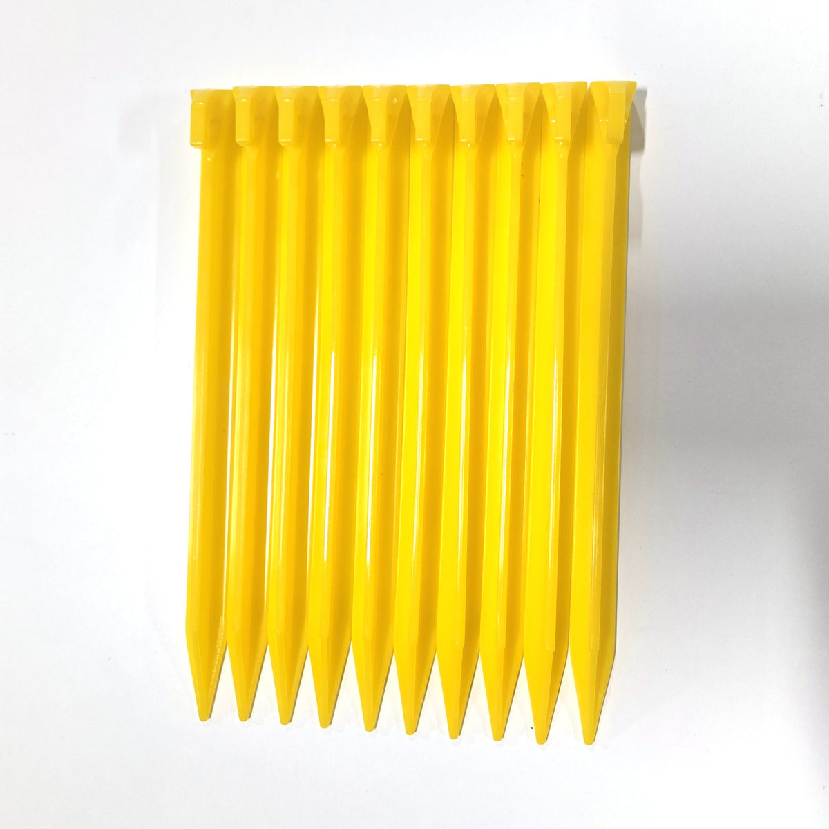 Pack of ten yellow BruteLine ground pegs side by side
